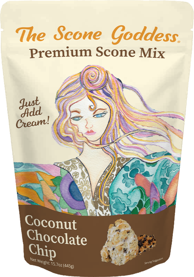 A stand-up pouch of The Scone Goddess Premium Scone Mix, Coconut Chocolate Chip flavor. The packaging features a cream-colored top section with orange and brown text, and a colorful illustration of a woman with flowing hair.