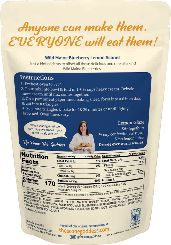 A stand-up pouch of The Scone Goddess Premium Scone Mix, Wild Maine Blueberry Lemon flavor. The packaging features a cream-colored top section with orange and blue text, and a colorful illustration of a woman with flowing hair.